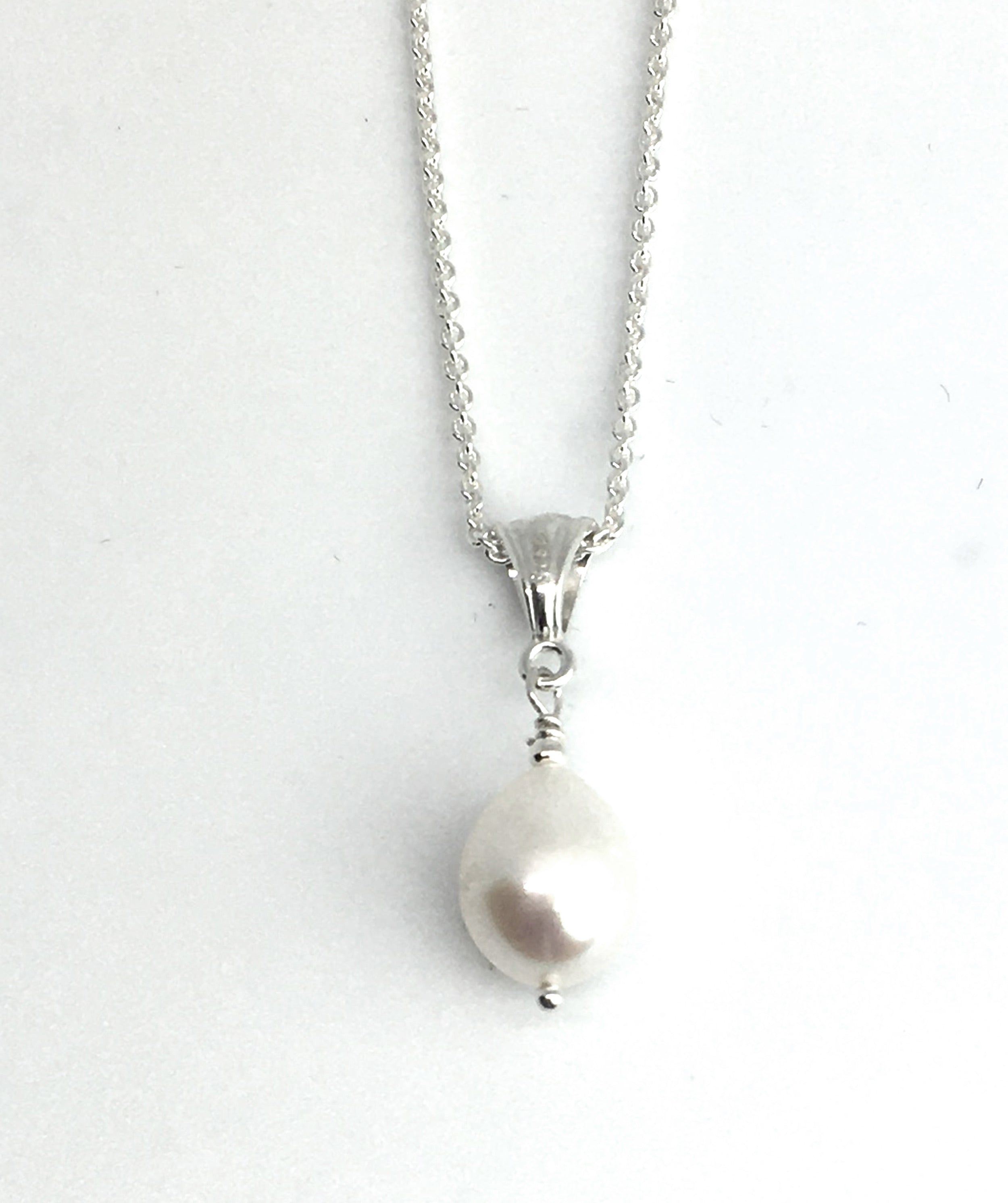 single white pearl pendant on silver cable chain necklace